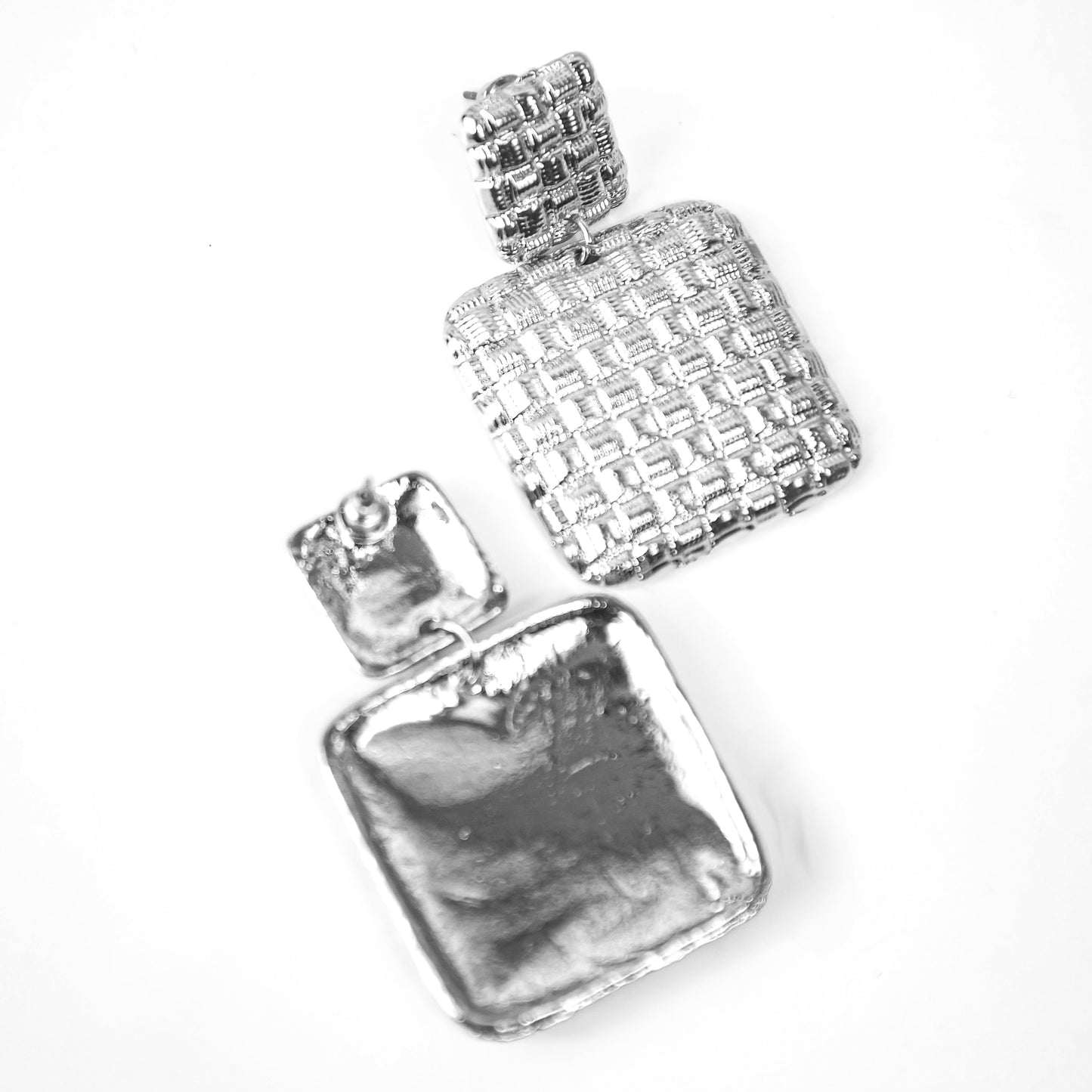 Two silver perfume bottles on a white background