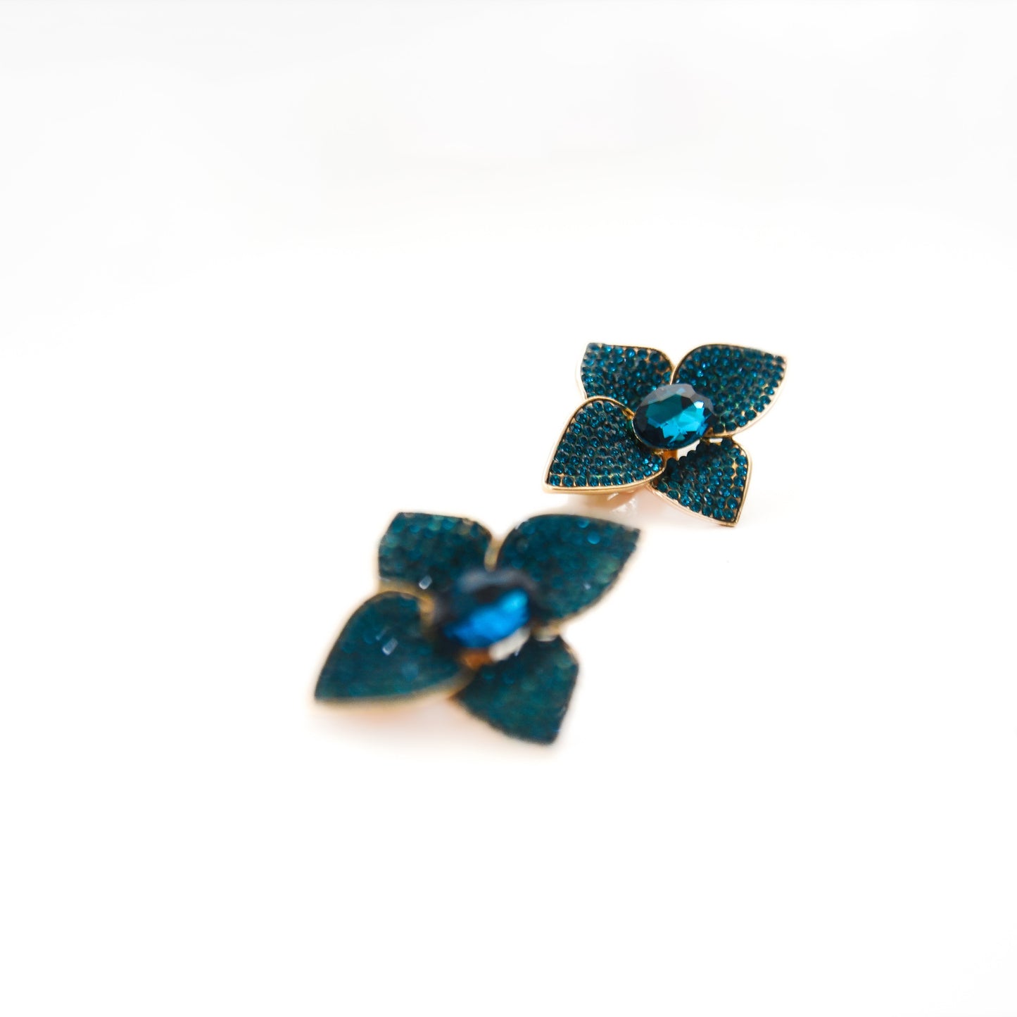 Decorative brooch with blue gemstones on a white background
