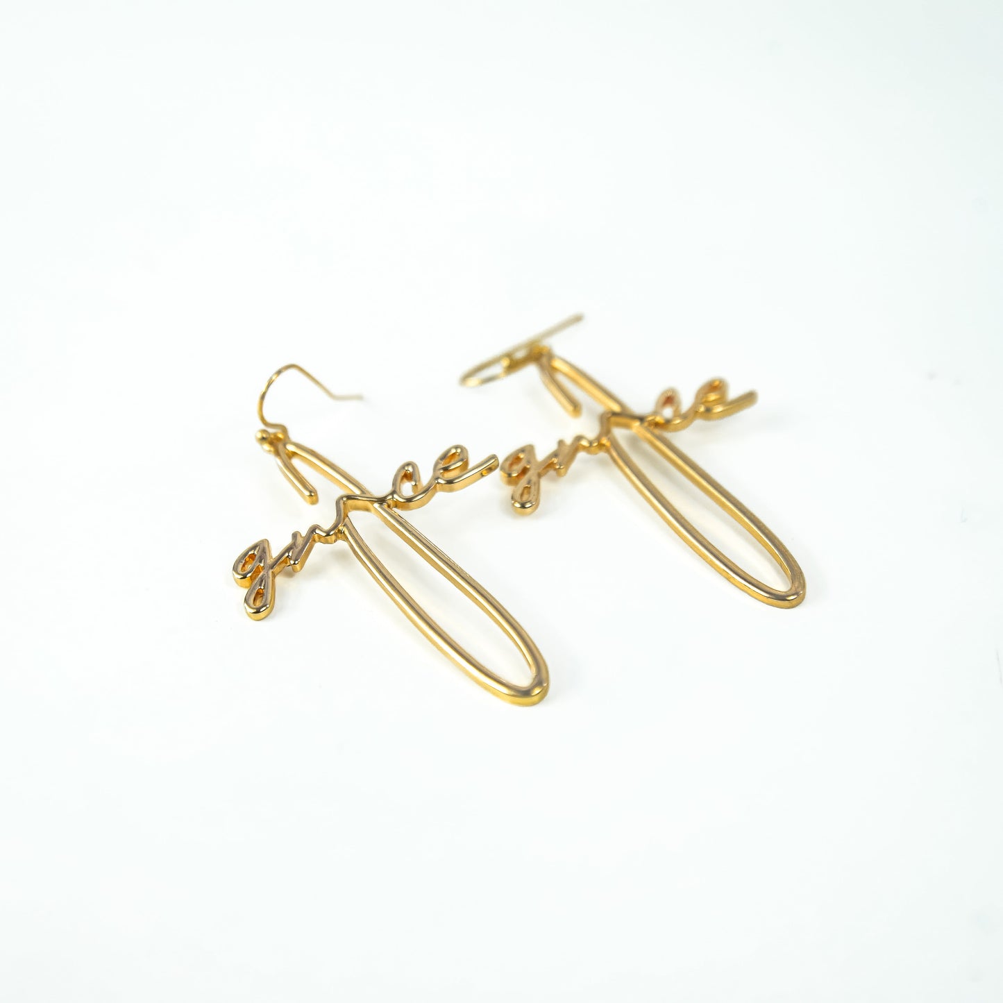 Gold earrings on a white background