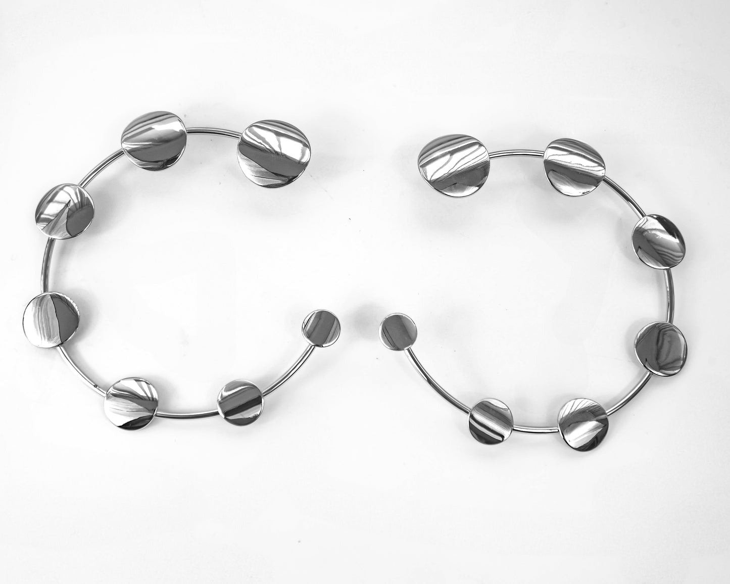 Pair of silver hoop earrings on a white background