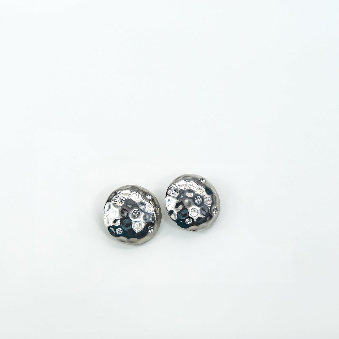Pair of silver earrings with gemstones on a white background