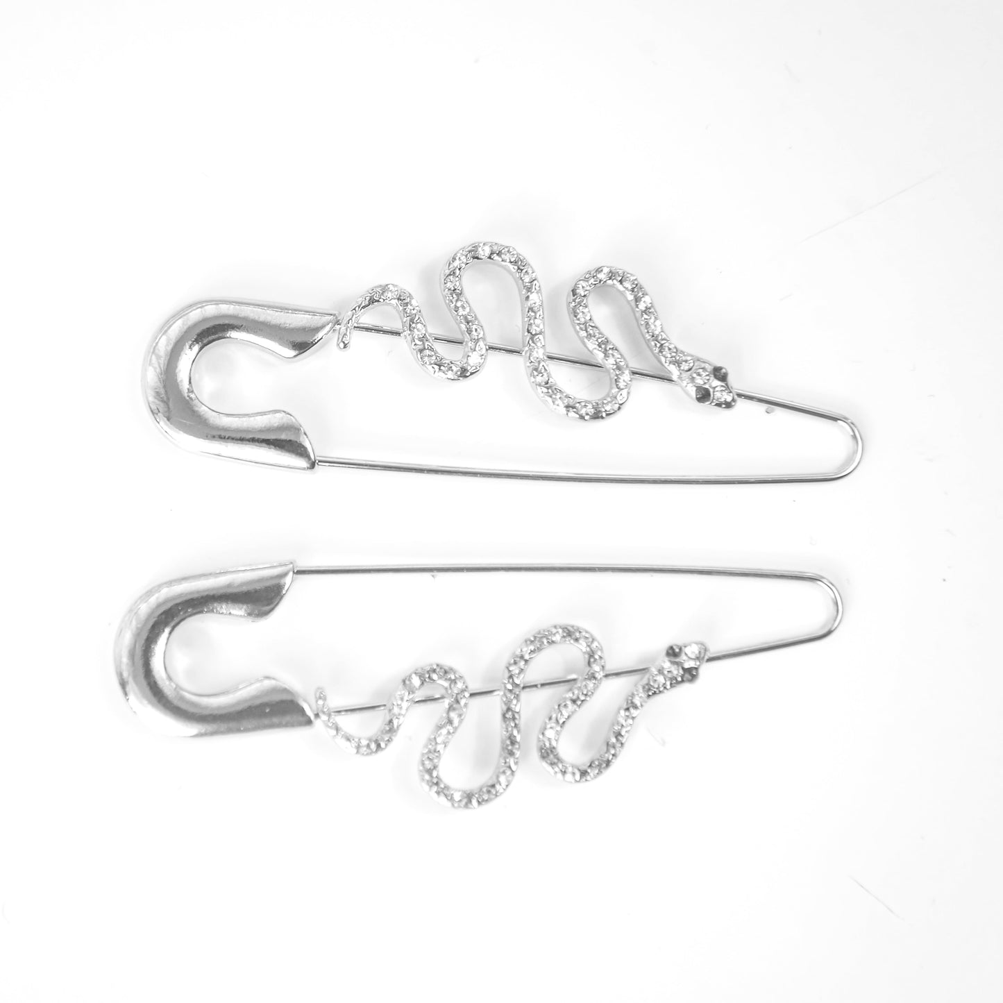 Two silver Earrings on a white background