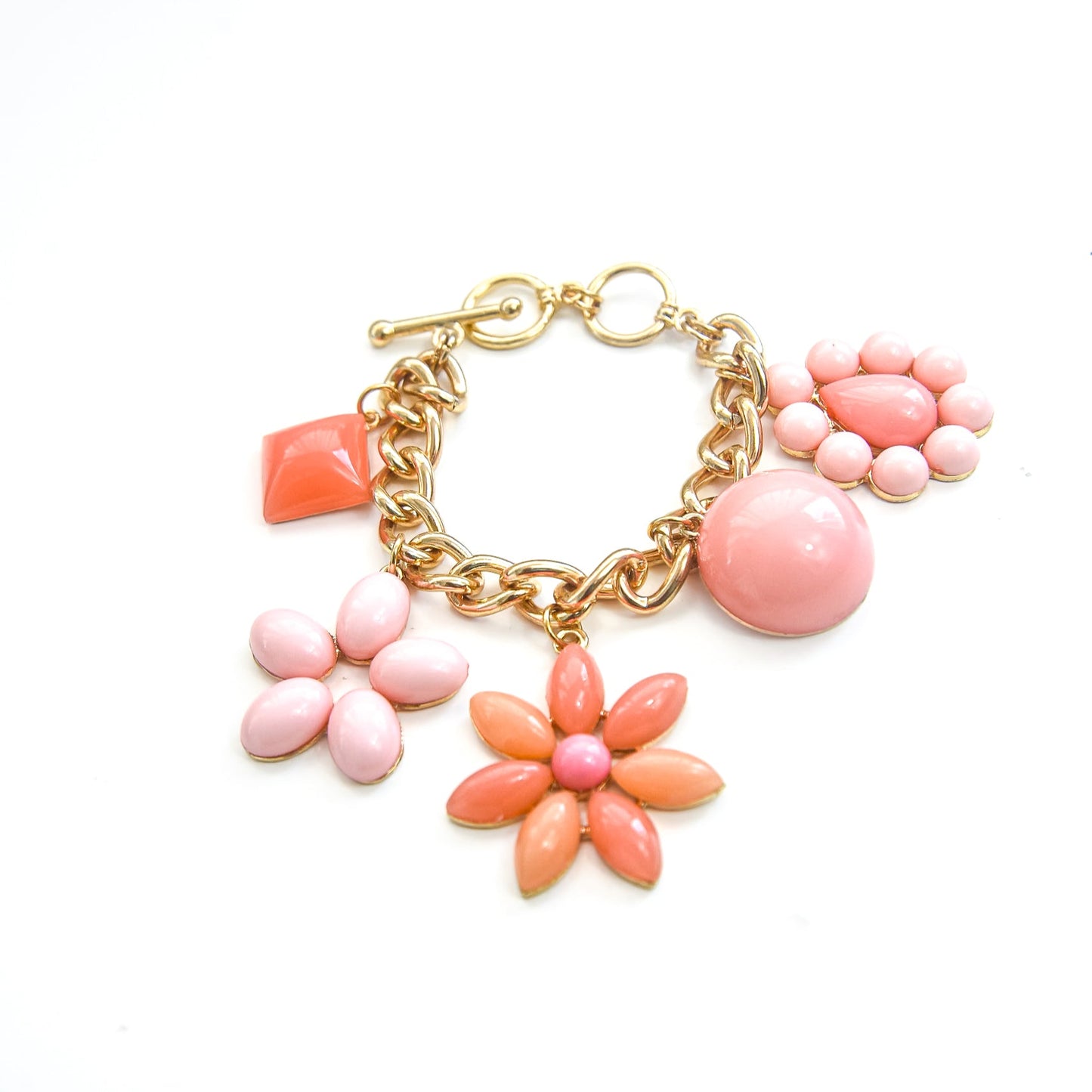Gold bracelet with pink and orange floral charms on a white background