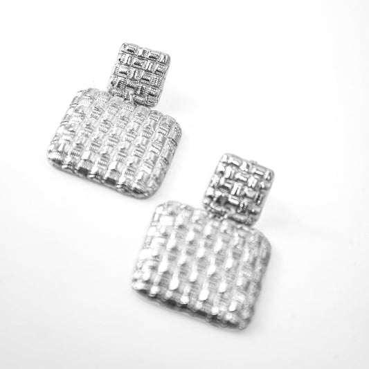 Pair of silver square earrings with clear stones on a white background