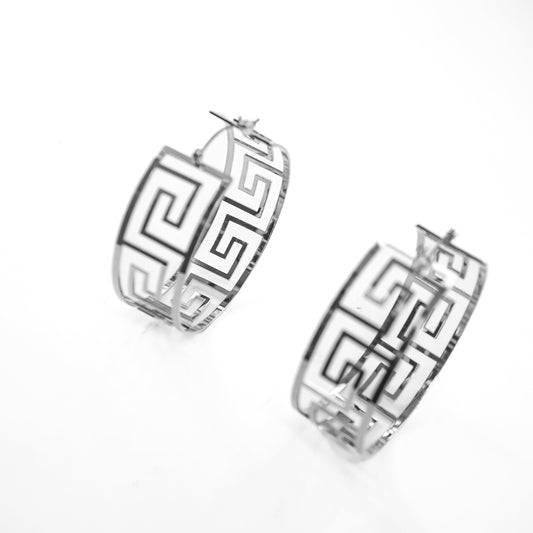 Pair of silver hoop earrings with geometric design on a white background