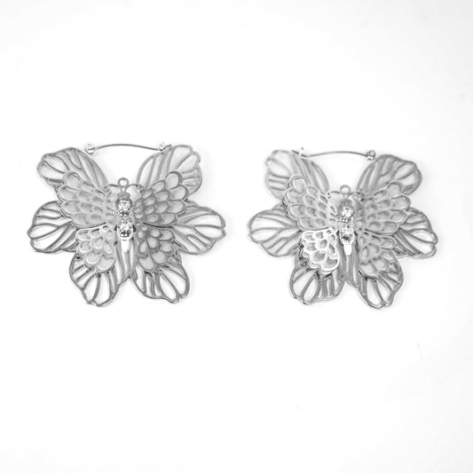 Pair of silver butterfly earrings on a white background