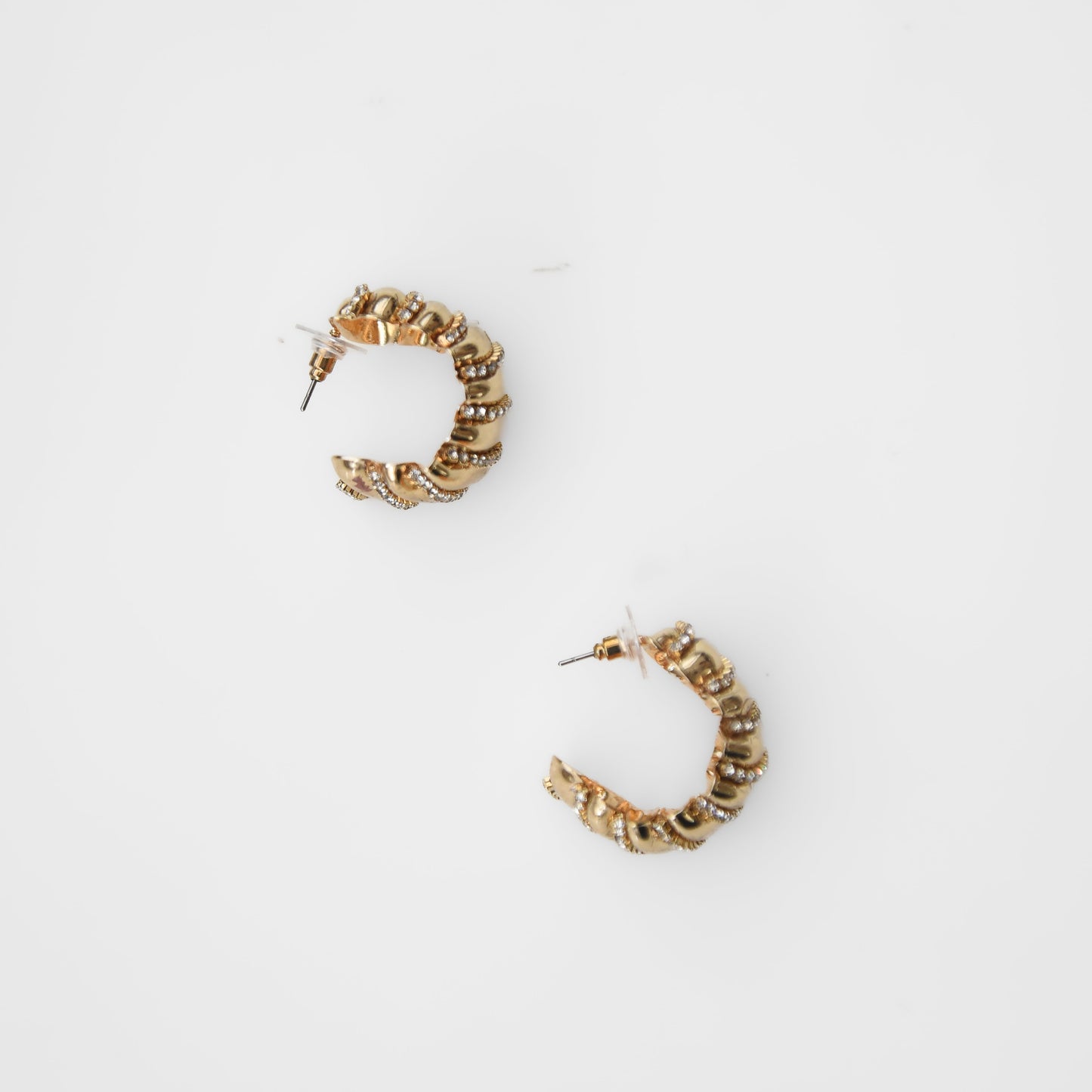 Gold hoop earrings on a white background