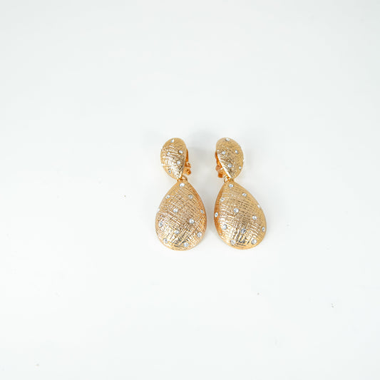 Gold earrings on a white background