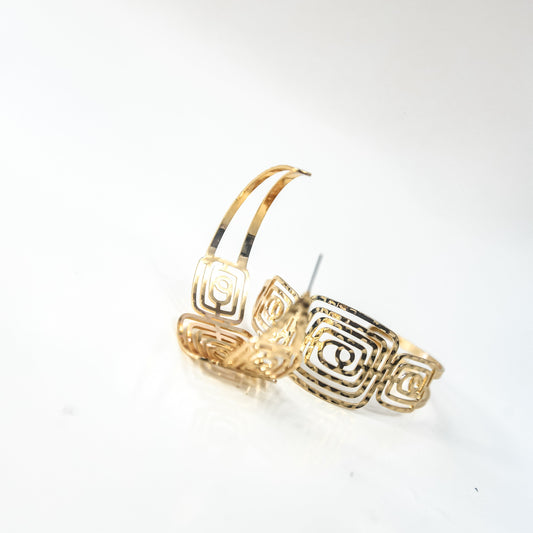 Gold hoop earrings on a light gray background