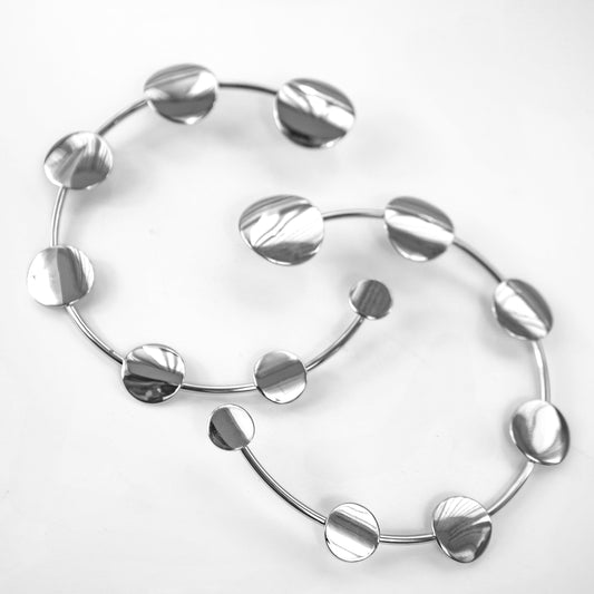 Two silver hoop earrings on a white background