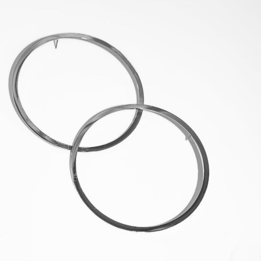 Two silver hoop earrings on a white background