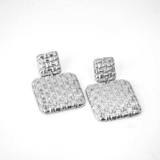 Pair of silver square earrings on a white background
