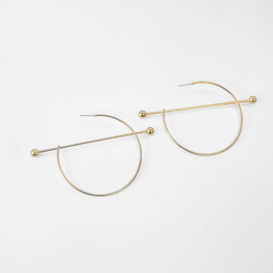 Gold hoop earrings on a white background