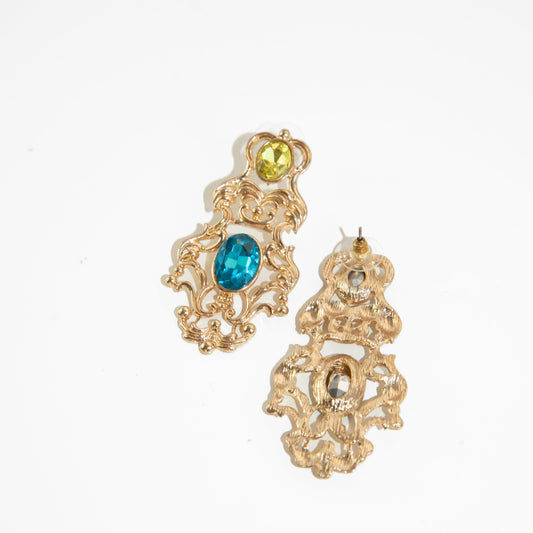 Gold earrings with gemstones on a white background