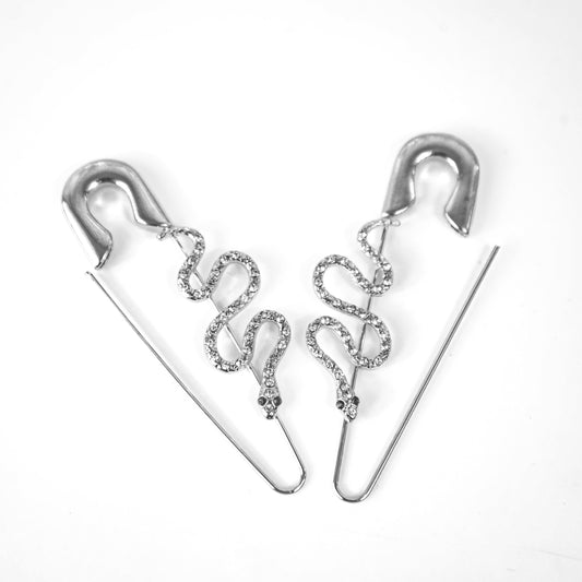 Silver earrings with snake design on a white background