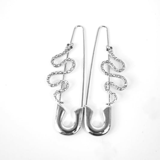Silver earrings with intricate designs on a white background