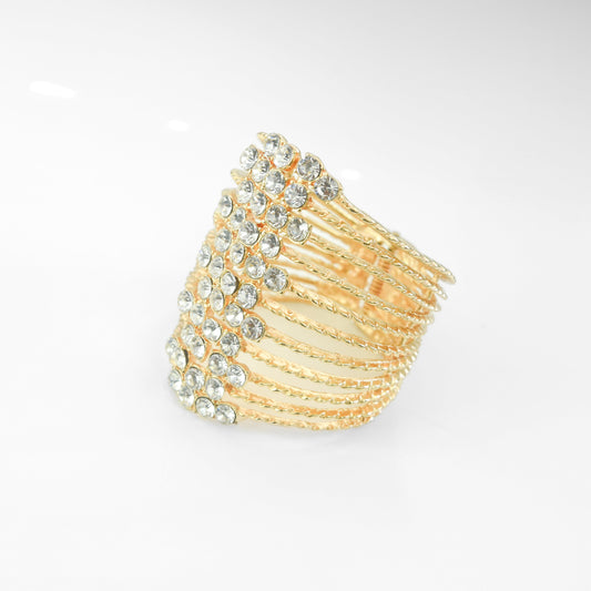 Gold bracelet with gemstones on a light gray background