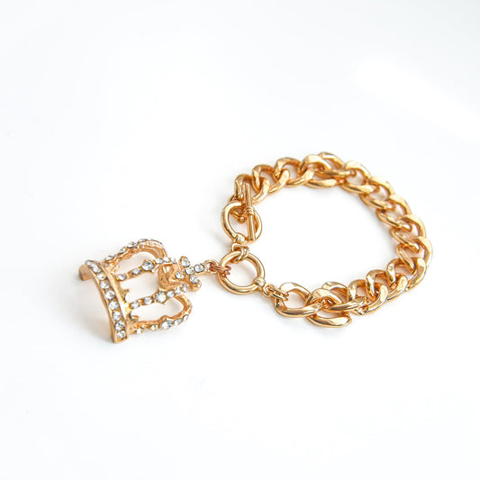 Gold chain bracelet with a decorative clasp on a white background