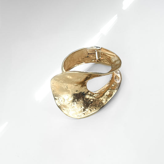 Gold bracelet on a white background