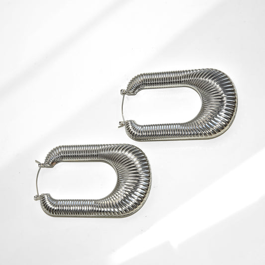 Pair of silver hoop earrings on a light gray background