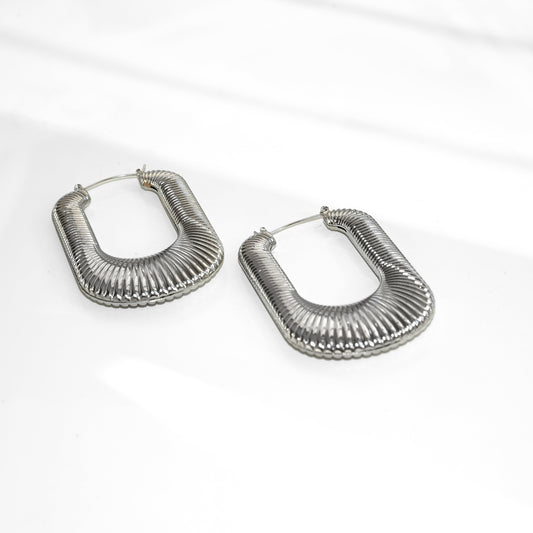 Pair of silver hoop earrings on a white background